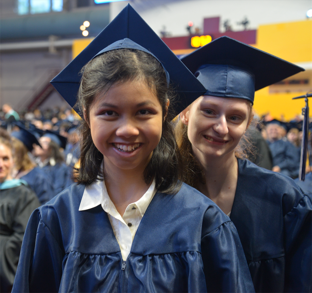  Students smiling in graduation caps